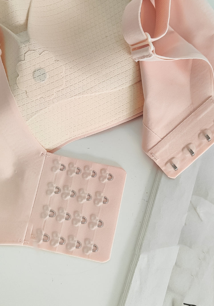 Chic Comfort Bra in soft pink, with an adjustable straps and hook detail, illustrating the bra's customizable fit and anti-slip straps.