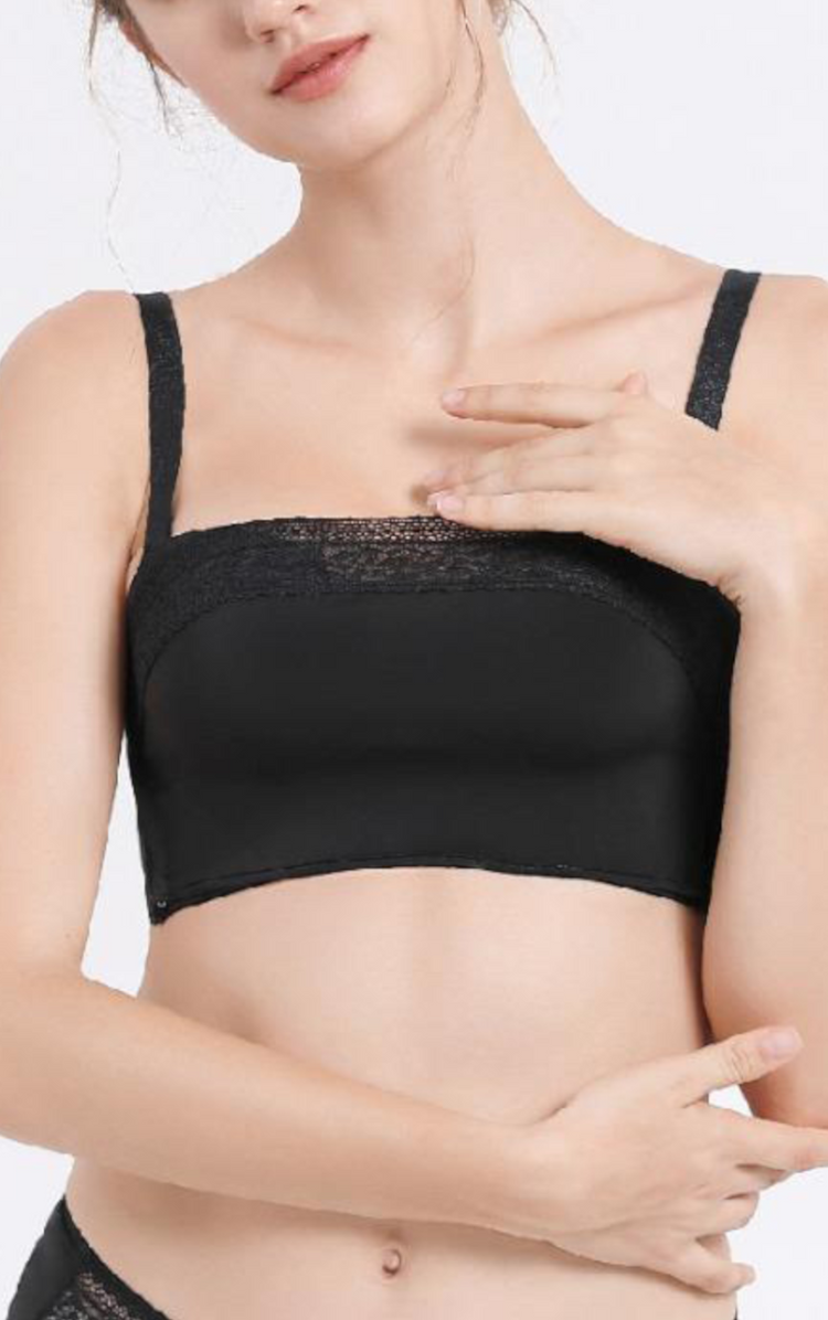 Woman wearing a black seamless push-up bra with a removable lace bandeau, showcasing the bra’s comfortable fit and strap design.