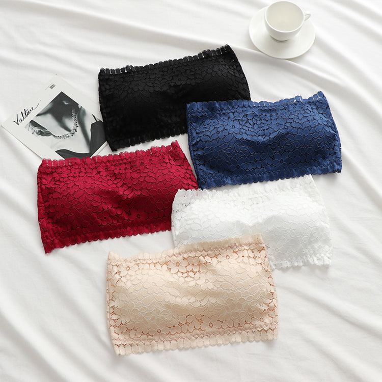 Set of five lace wireless tube top bras in black, blue, red, white, and beige displayed on a white surface, alongside a magazine and a white coffee cup.