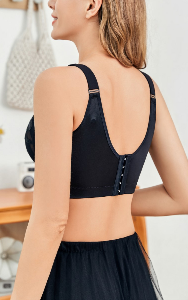 A back view of the woman wearing the black floral embroidery lace wireless bra, highlighting the wide sidebands and shoulder straps.