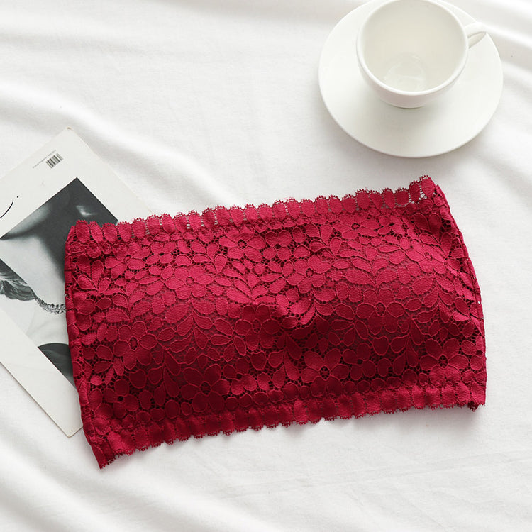 Red lace wireless tube top bra arranged on a white surface, showcasing lace details.