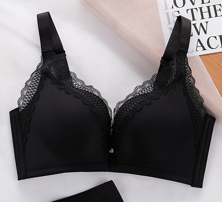 Close-up view of a black push-up bra, highlighting the lace detail and structure of the cups.